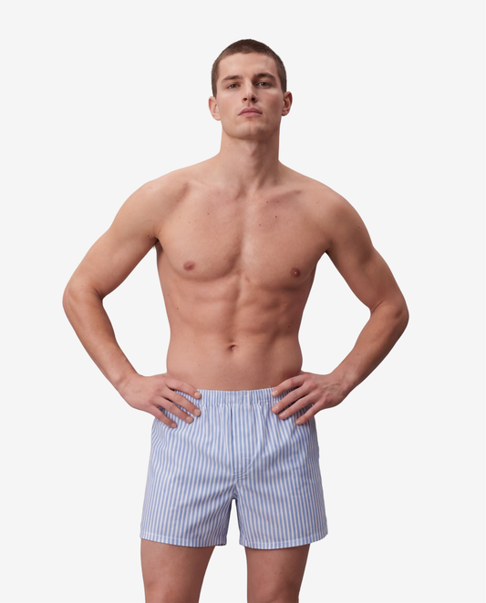 Model wearing Son of John Oxford Stripe boxer shorts, hands on his hips
