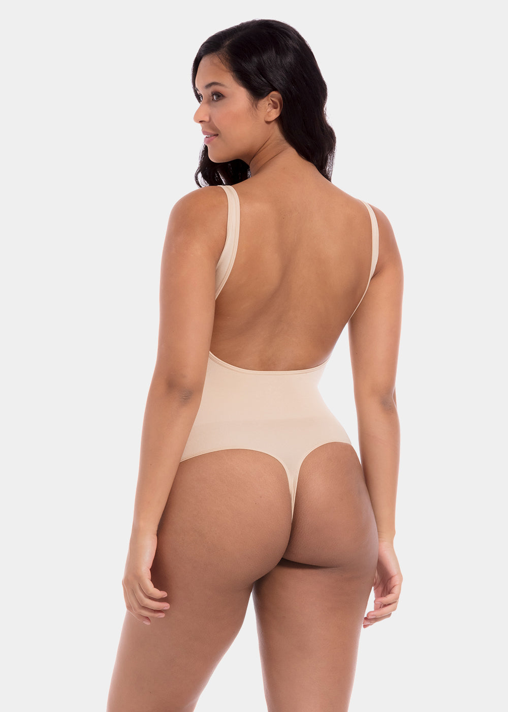 Woman wearing a beige bodysuit on a white background